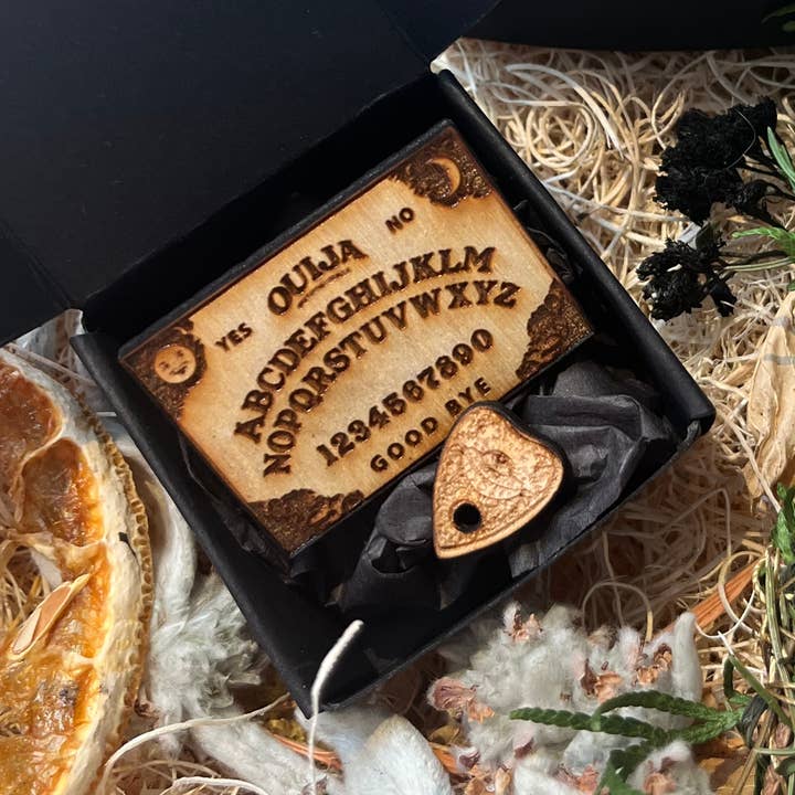 smallest traditional ouija board in a box for wholesale by The Chaotic Good (previously The Great Cosmic Trust)