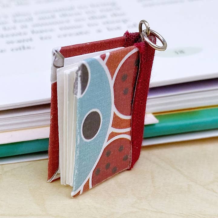 Sparkle Cinnamon Burst Book Pendant- Silver for wholesale by Nicolette Tallmadge Designs