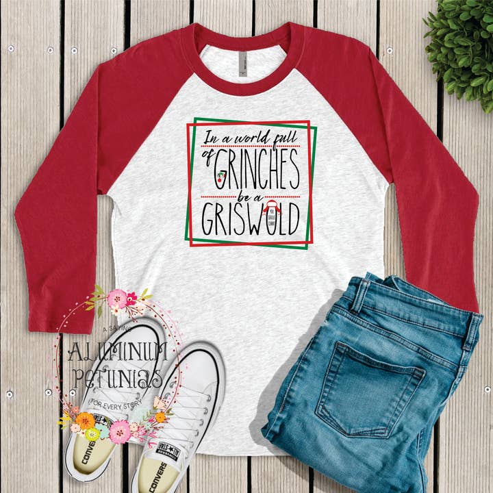 In a World Full of Grinches be a Griswold Graphic Tee for wholesale by Aluminum Petunias