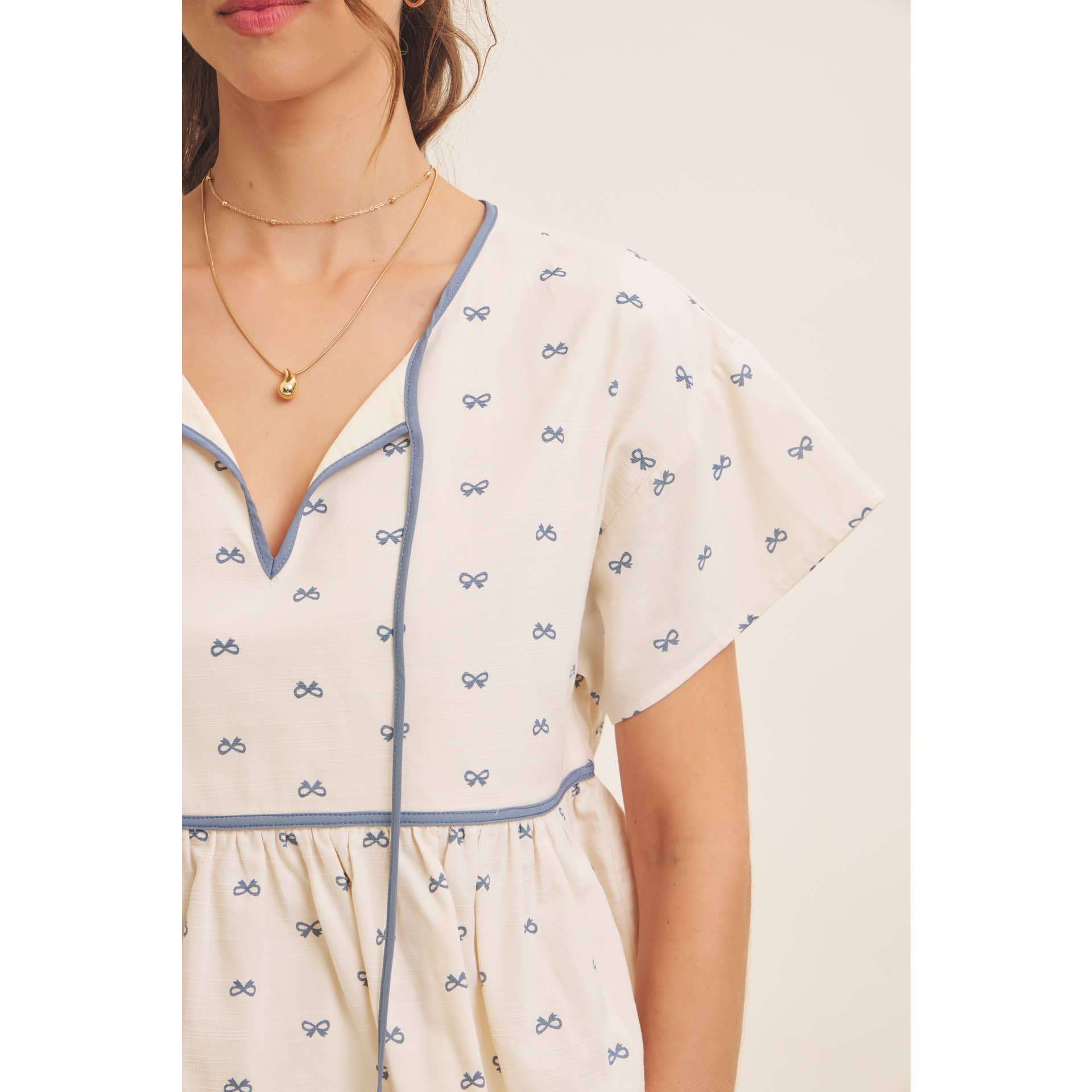 in february - Wholesale Blouse - Women's - SUNNY DAYS BOW PRINT BABYDOLL BLOUSE WITH CONTRAST BINDING3