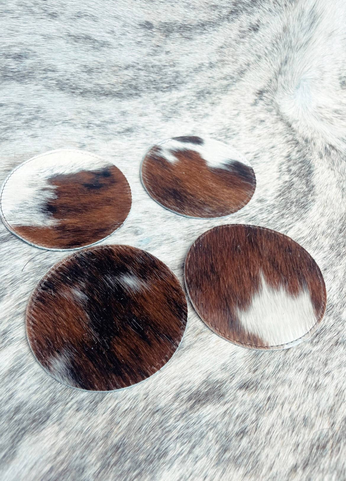 Wholesale Classic Cowhide Coasters 4pc Set for your store Faire