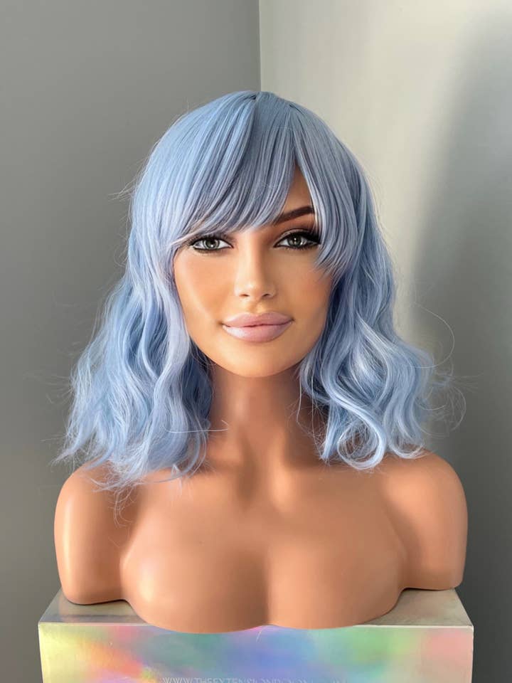 "Faye" - Korte Pastelblauwe Body Wave Pruik met Pony voor wholesale door The Extension Room