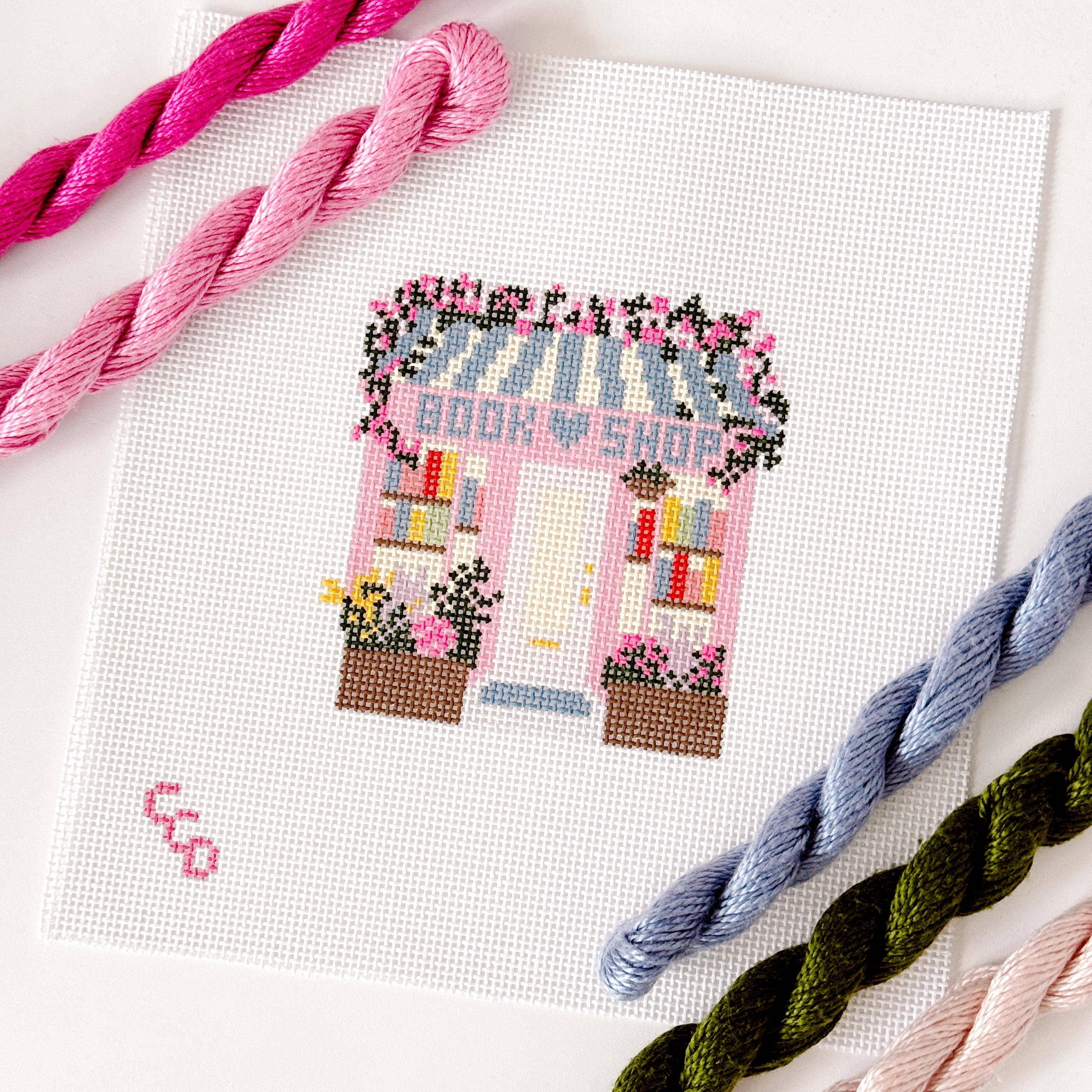 Cotswold Co Designs - Wholesale Embroidery/Cross Stitch Supplies - Ready to Ship Hand Painted Book Shop Storefront 6” Needlepoint Canvas 13 Mesh Reading Needlepoint Canvas Storefront Hand Painted3