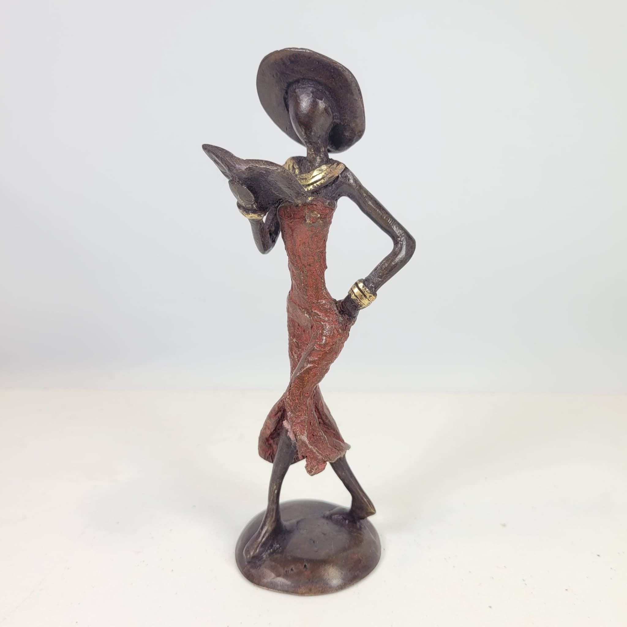 Moogoo Creative Africa - Wholesale Sculpture - Bronze sculpture “Femme avec livre et chapeau” by Soré | vers9