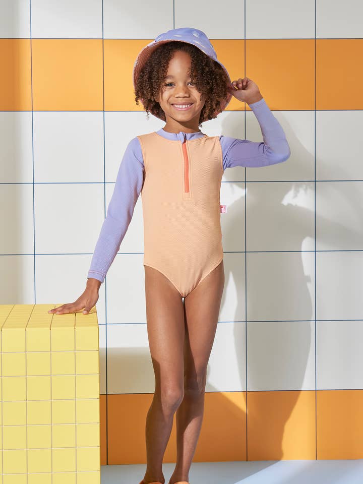 Peach Ribbed Kids Long Sleeve Swimsuit and other Purchase wholesale swim wear. Free returns & net 60 terms on Faire trending on Faire.