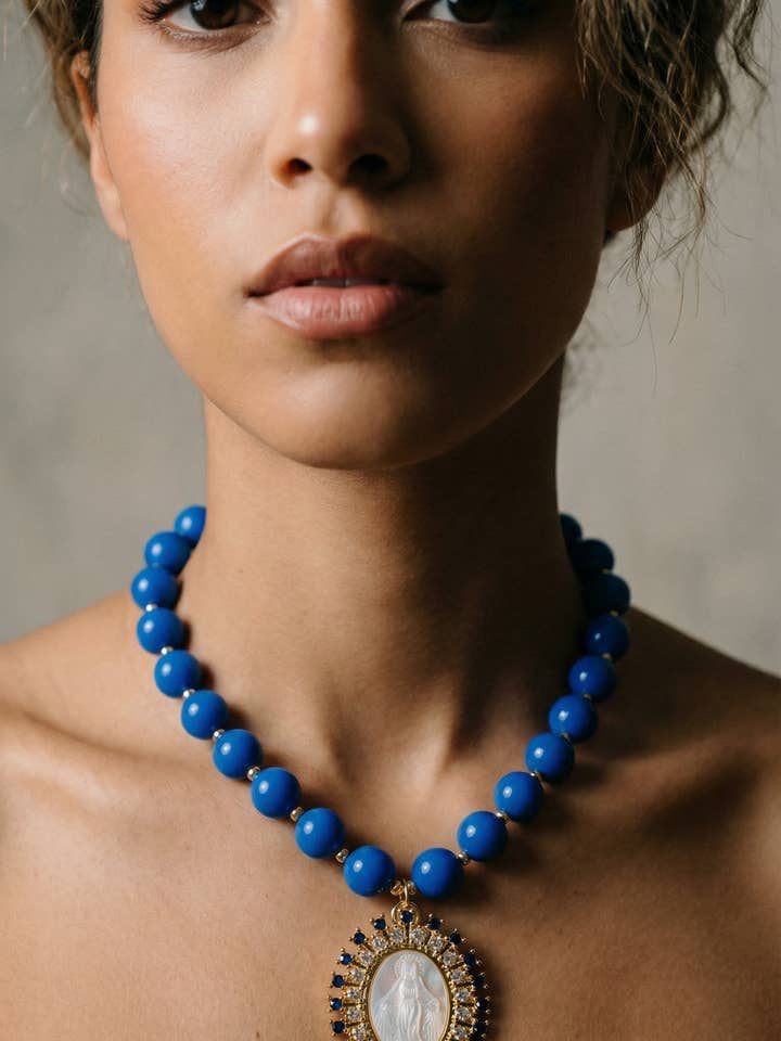 Blue beaded necklace with Virgin medal pendant for wholesale by PHOEBE´S
