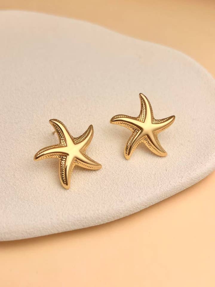Gold starfish earrings in stainless steel for wholesale by COSMOS