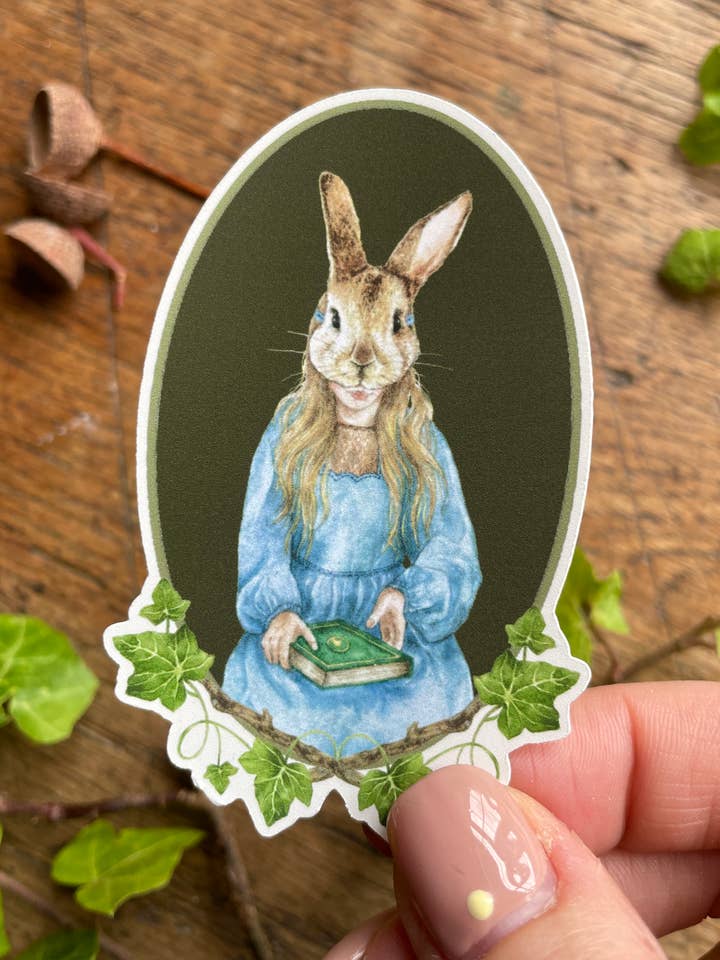 Girl in Rabbit Mask Oval Matt Vinyl Sticker | Curious Art for wholesale by Georgiou Draws