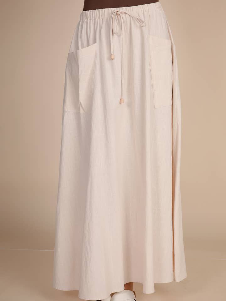 JUPE LONGUE EN LIN AVEC POCHES LATÉRALES pour la vente par Hers & Mine
