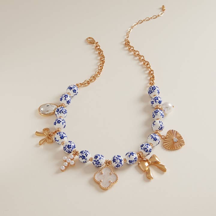 Gold Mixed Metal Charms Ceramic Beads Swag Necklace for wholesale on Faire