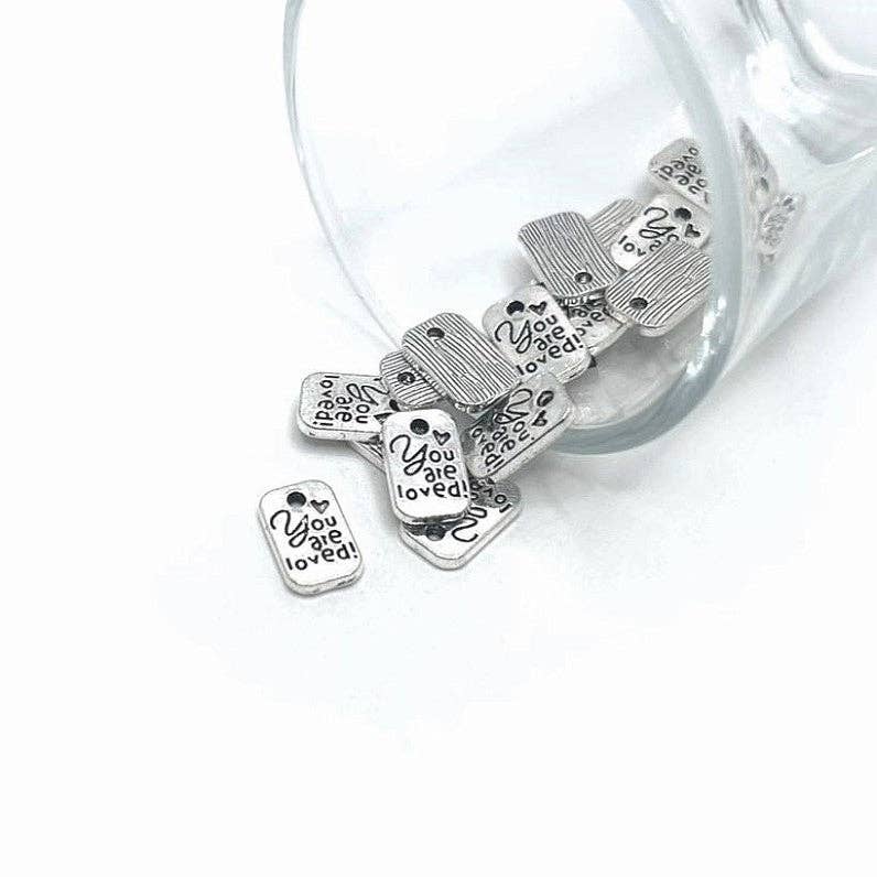 Guerrilla Charm – wholesale Individual charm/pendant – Tiny Silver You Are Loved Affirmation Charms, 11x7mm0