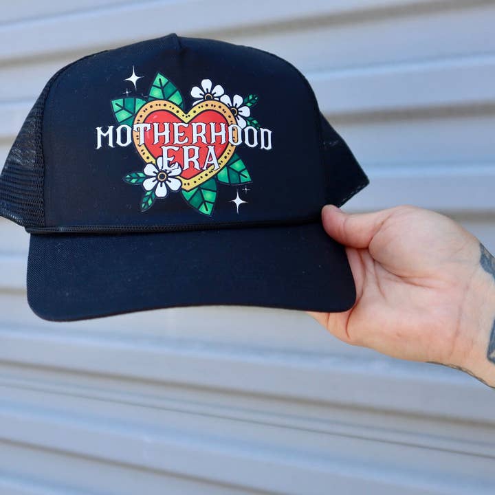 Black Tattoo Motherhood Era Trucker Hat for wholesale on Faire
