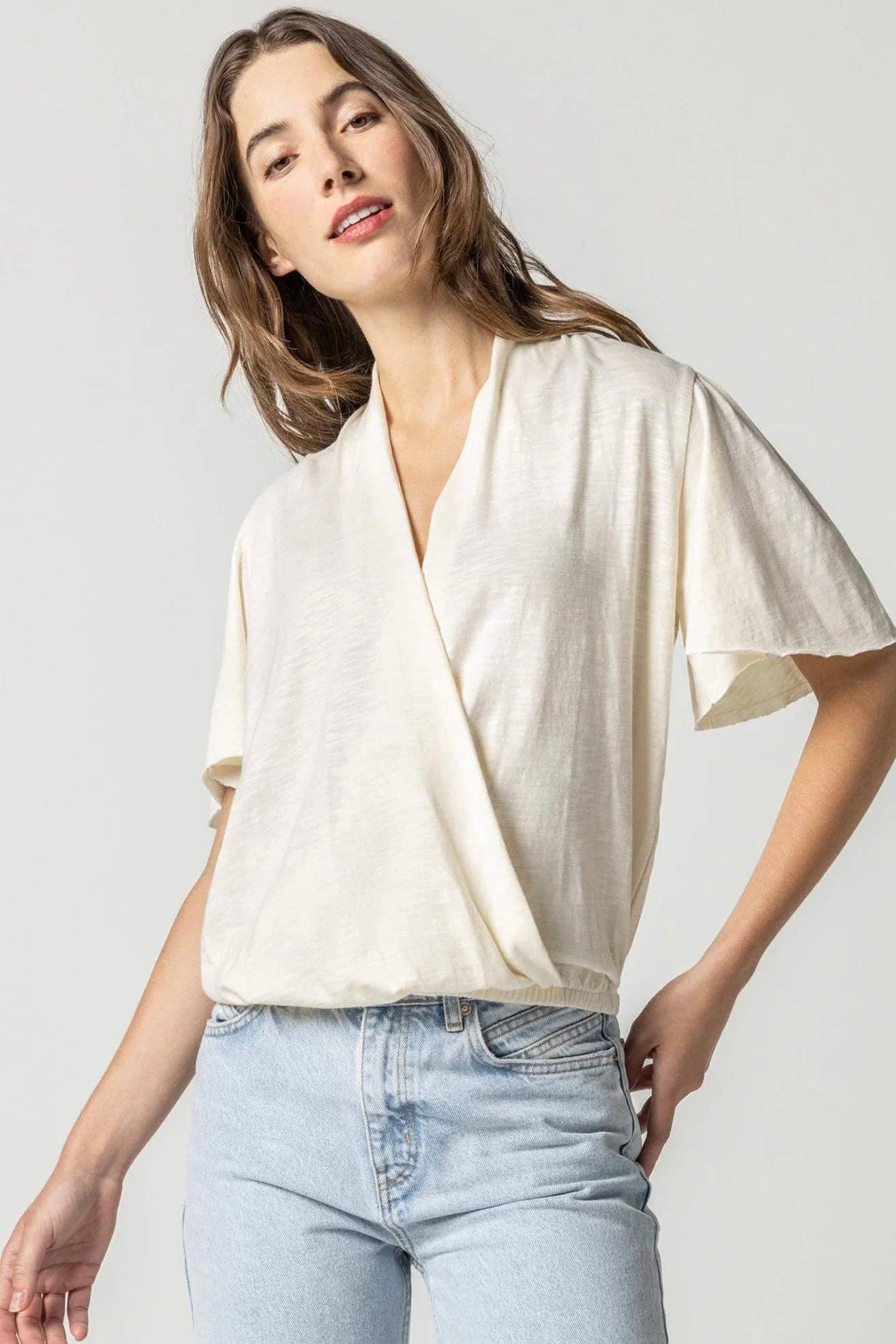 Talc Lilla P Faux Wrap Flutter Sleeve Top for wholesale on Faire