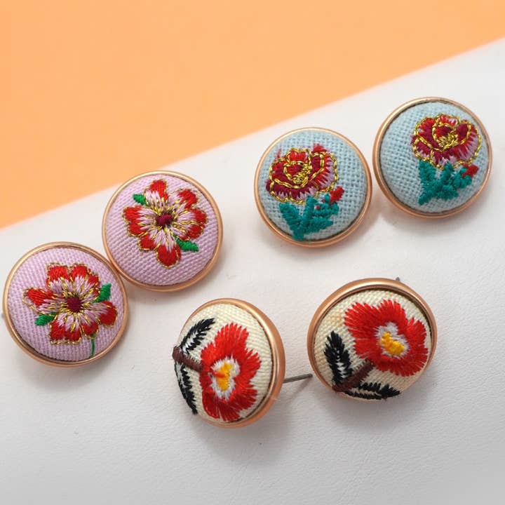 EMBROIDERY FLORAL GOLD EDGE STUD EARRINGS | 80E61042 and other Purchase Wholesale hamilton market. Free Returns & Net 60 Terms on Faire trending on Faire.