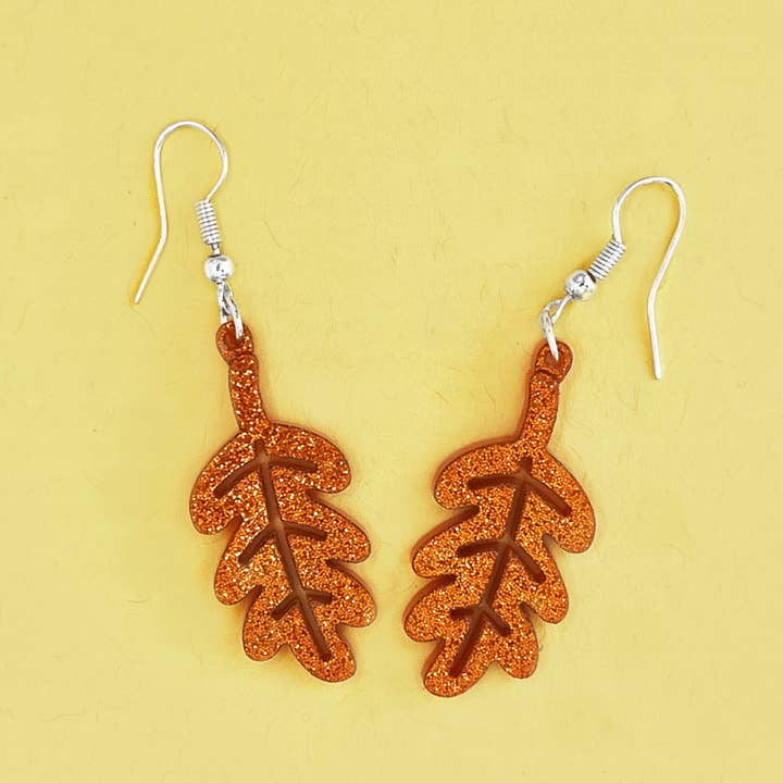 Boucles d'oreilles pendantes feuille scintillante pour la vente par Vic Tac Toe