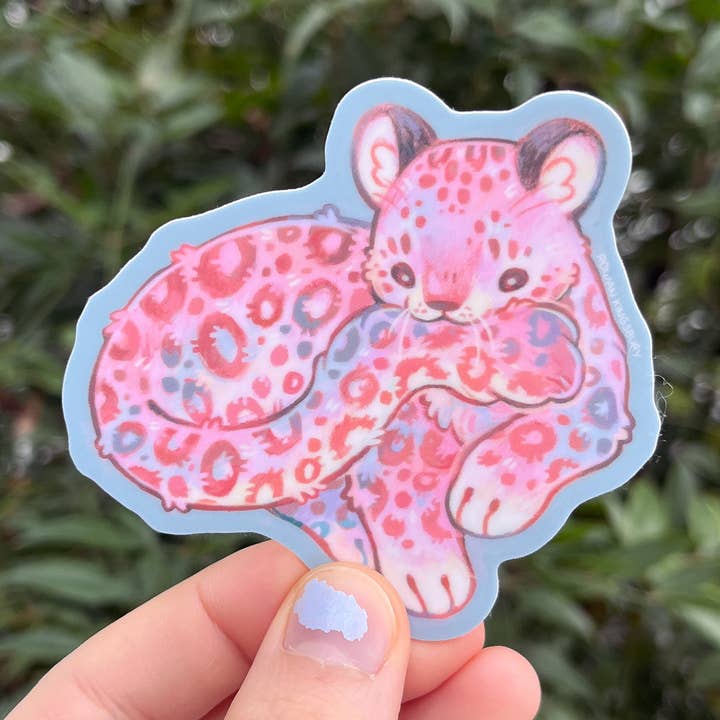 Cuddly Snow Leopard Vinyl 3" Sticker for wholesale by Rowan Kingsbury