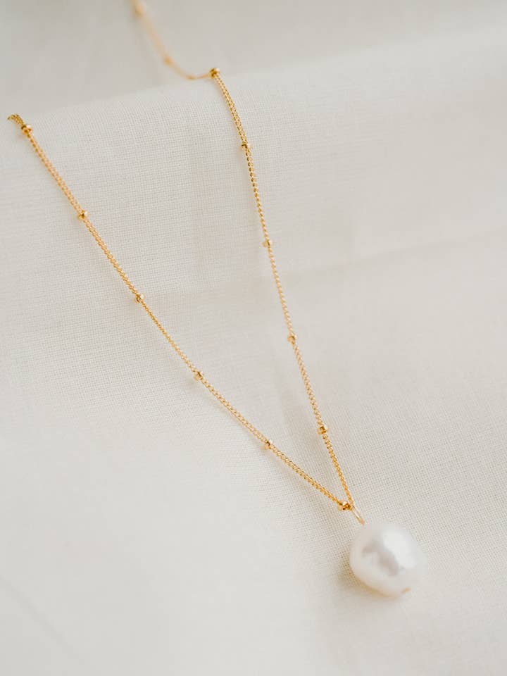 Ari Saturn Pearl Necklace for wholesale by Dainty & Daring