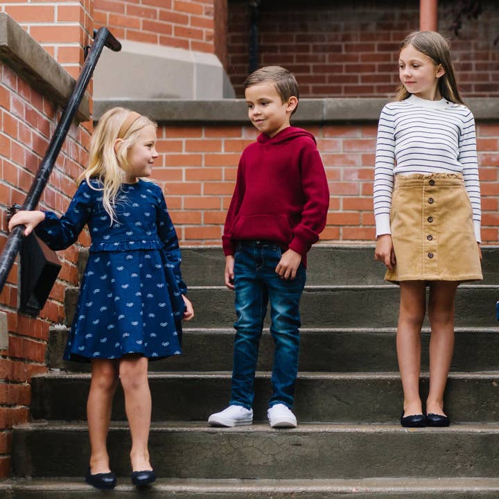 Navy Bicycle Print Ruffle Waist Dress - Made with Organic Cotton for wholesale on Faire