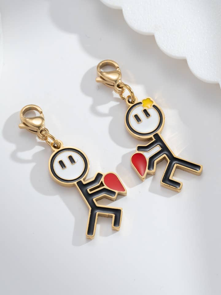 “Toi & Moi” duo charms with golden figures, red steel heart for wholesale by COSMOS