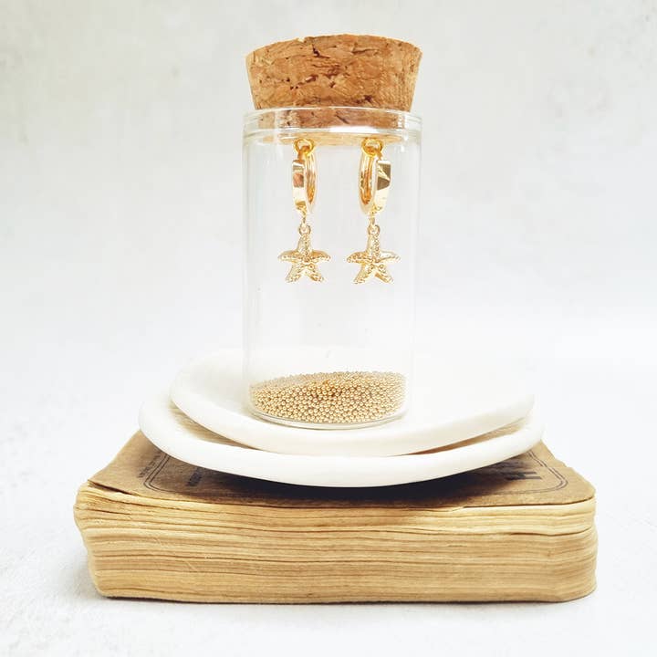 Gold Starfish Huggie Earrings in a bottle for wholesale by Zamsoe