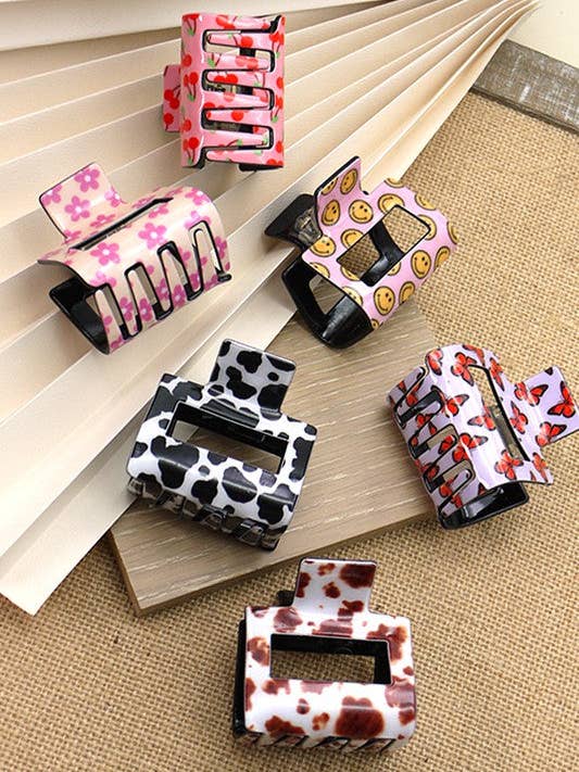 TRENDIGE PREMIUM-HAARKLAMMER — SMILEY, BLUME, KIRSCHE, KUH, SCHMETTERLING | 40H479 für den Großhandel von JOSSLYN by wall to wall