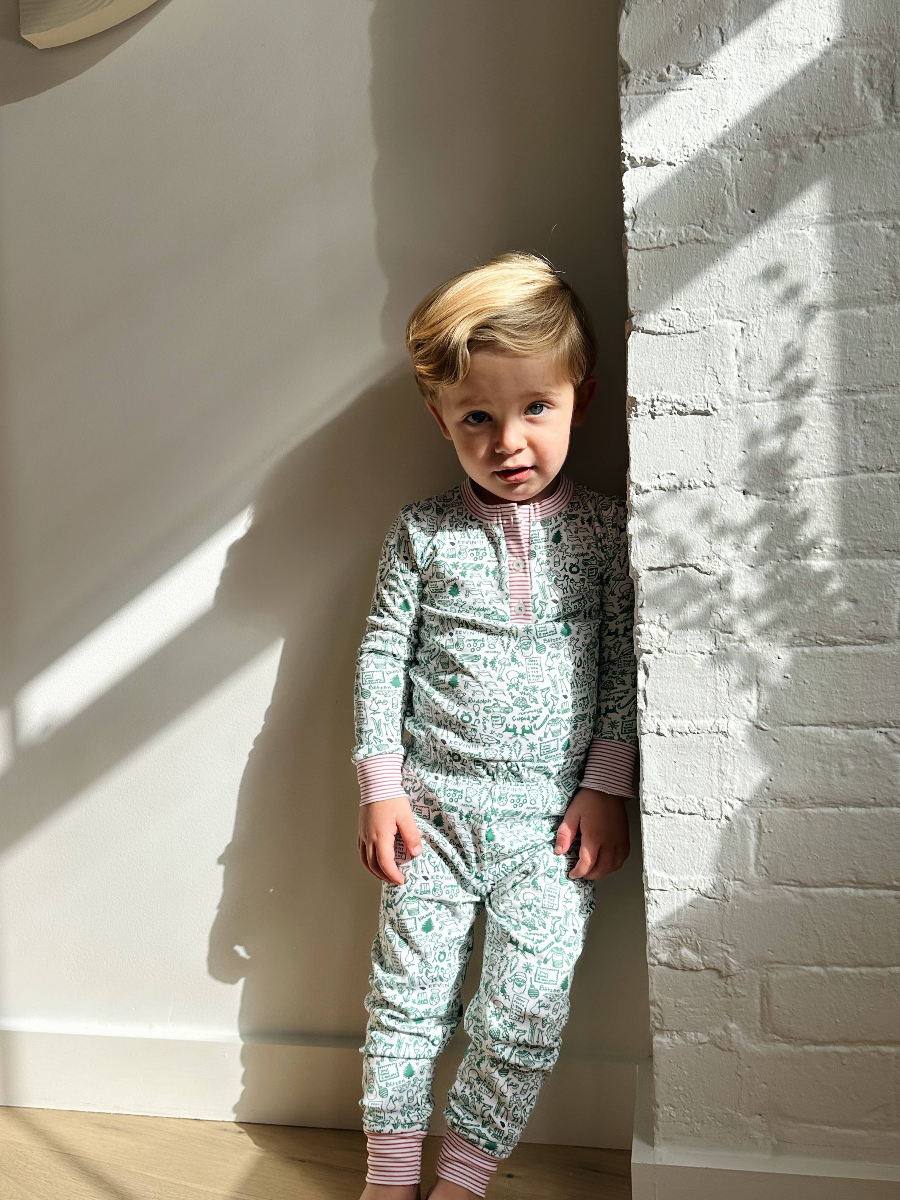 North Pole Christmas Two Piece Kids Henley Pajamas for wholesale on Faire1