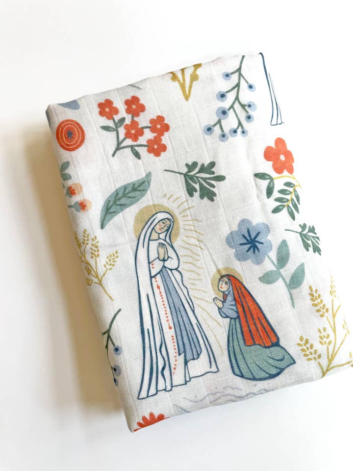 The Stump of Jesse - Wholesale Swaddle - Baby - Our Lady of Lourdes & St. Bernadette Deluxe Swaddle Catholic