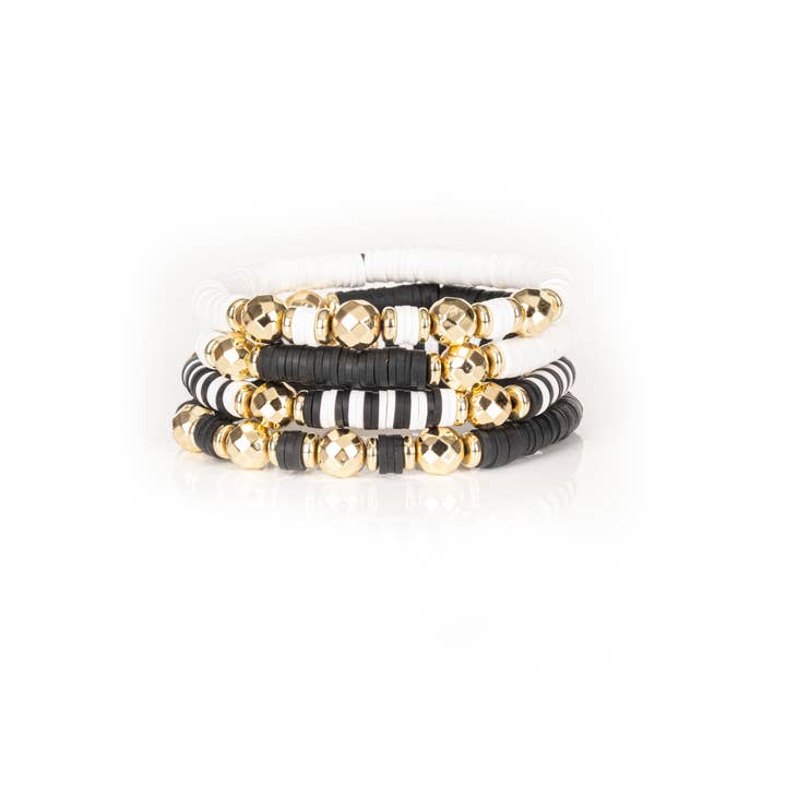 Le set de bracelets superposés Monochrome Muse noir, blanc et or pour la vente par The Dark