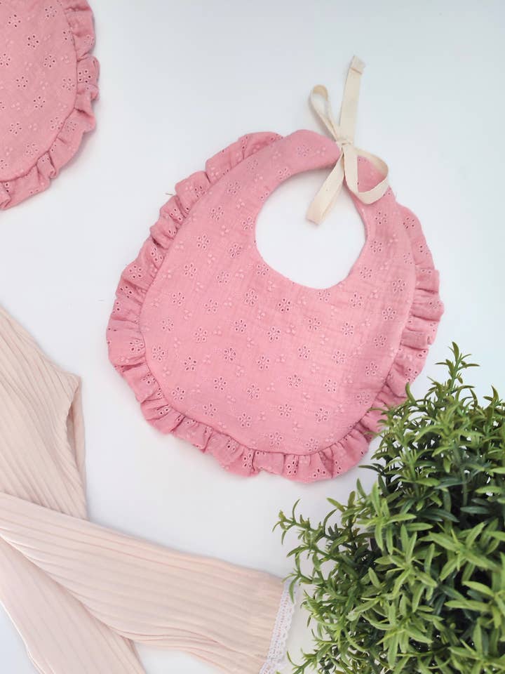 Pink ruffle bib for wholesale by Petiteaude