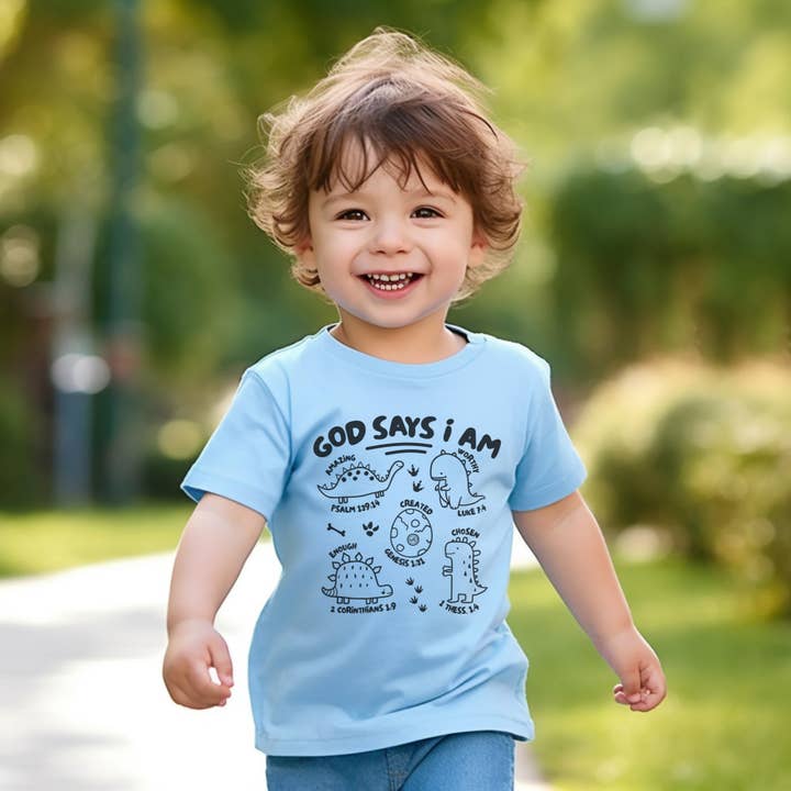 God says I am Dinosaurs Kid's Christian Graphic Tee for wholesale by Never Lose Hope Designs