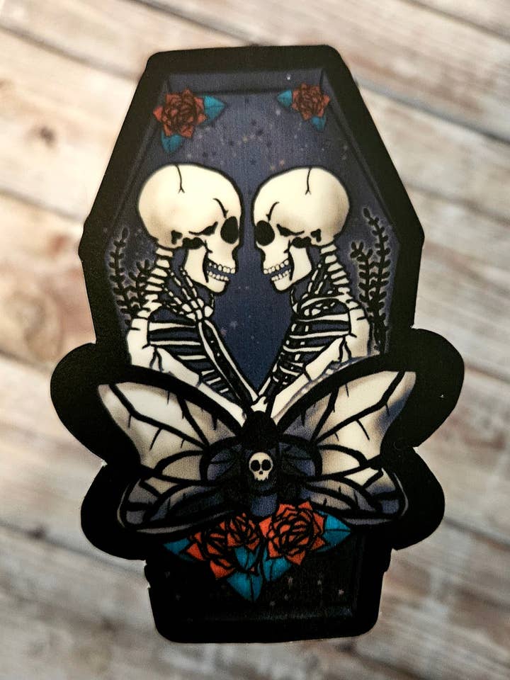 Skeleton lovers in a coffin sticker for wholesale by Unsupervised Art