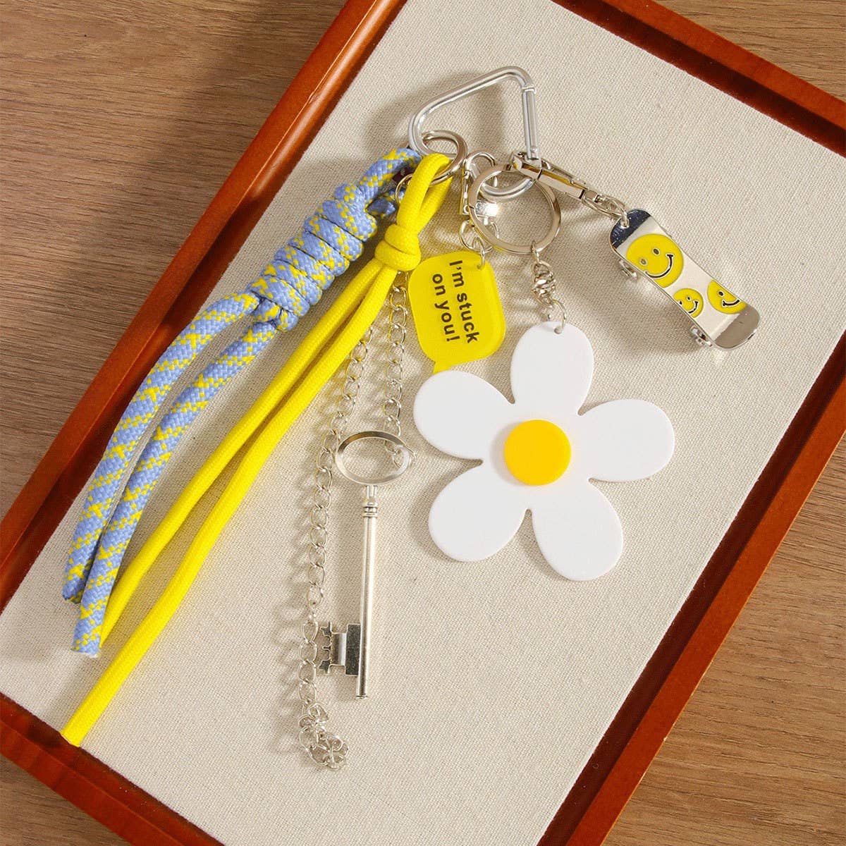 White Mini Skateboard Keychain with Daisy & Letter Charm_CWMM7551 for wholesale on Faire1