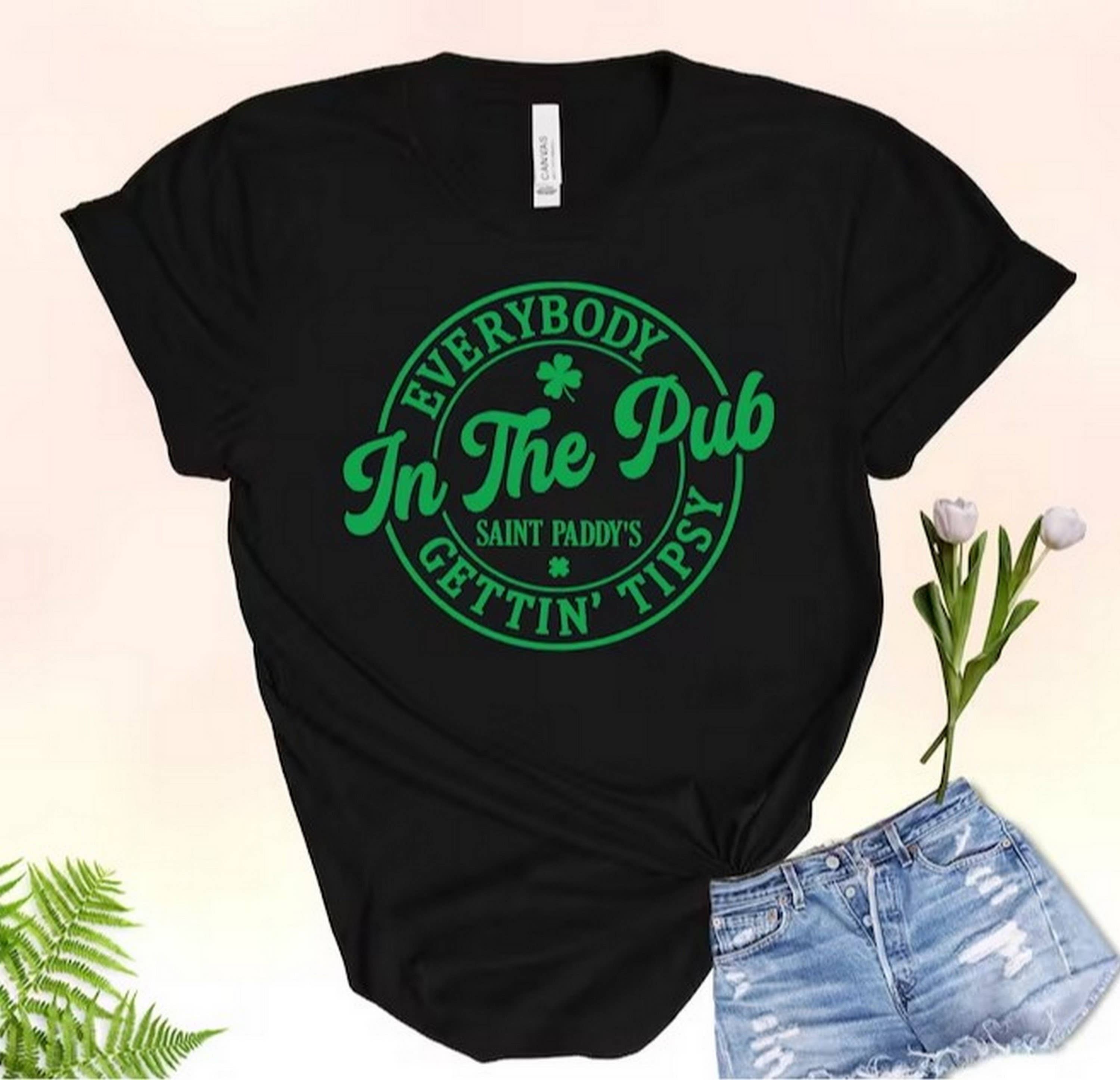 Black Everybody in the Pub getting tipsy t-shirt, St. Patrick's Da for wholesale on Faire