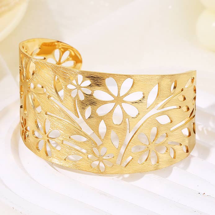 Adjustable gold cuff bracelet adorned with flowers for wholesale by JOYA