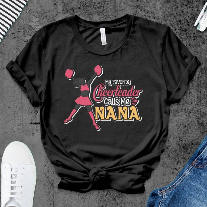 Cheerleader Nana T-Shirt, My Favorite Cheerleader Calls Me Nana, Cheer Mom Tee, Family Support Shirt, Cheer Grandma Gift, Pink Black Top for wholesale by FreakyTeeFactory