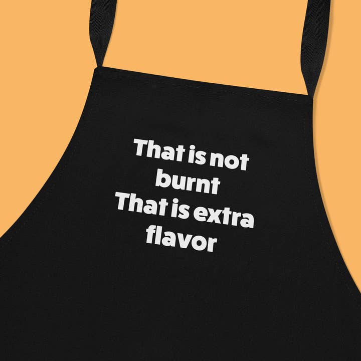 Avental de cozinha preto com texto engraçado - Não está queimado. É sabor extra. por atacado de Deadpixel