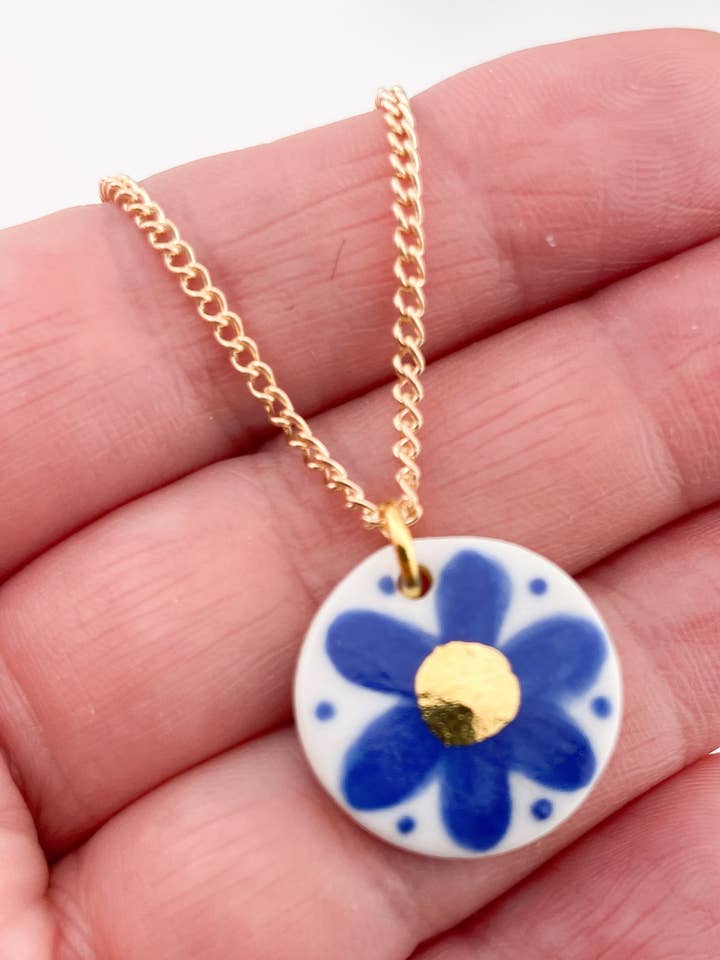 Hand Painted Dark Blue Flower Pendant necklace w gold centre for wholesale by Clay Blanca