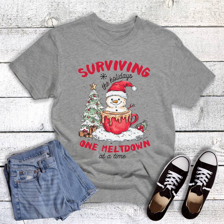 Christmas Surviving the Holidays One Meltdown Graphic Tee for wholesale by Dust and Roots