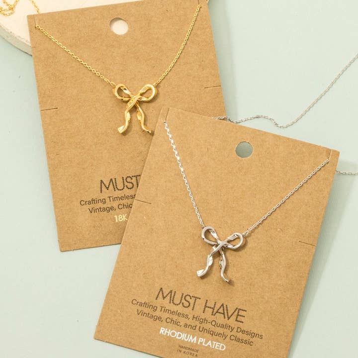 Gold Dipped Long Ribbon Bow Pendant Necklace for wholesale by Fame Accessories