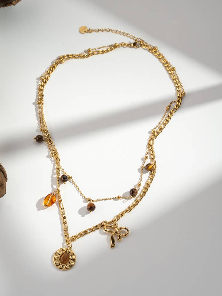 Gold bracelet with celestial sun and heart charms for wholesale by COSMOS