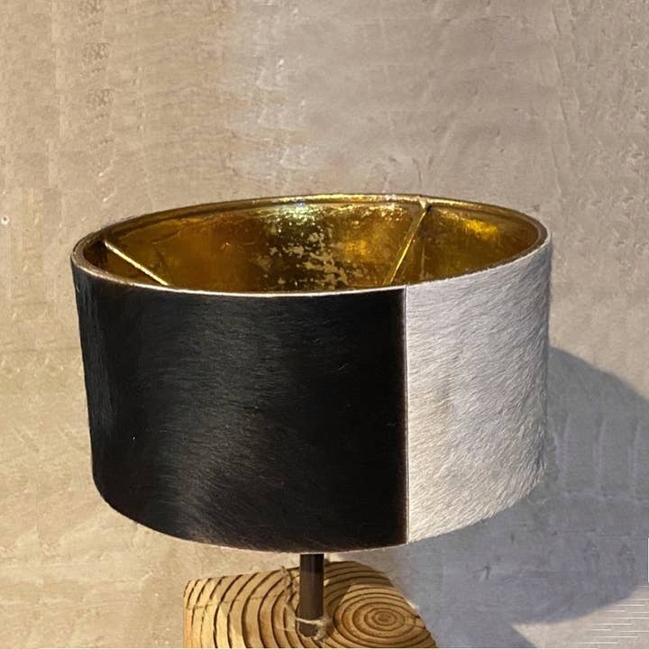 Round lamp shade in metal and cowhide for wholesale by LES SCULPTEURS DU LAC