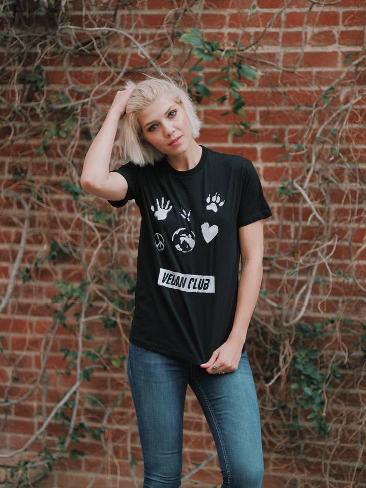 Vegan Club T-shirt feat. a paw, heart, hand, peace sign and Earth artwork by artist Brandi Jae for wholesale by Vegan Club