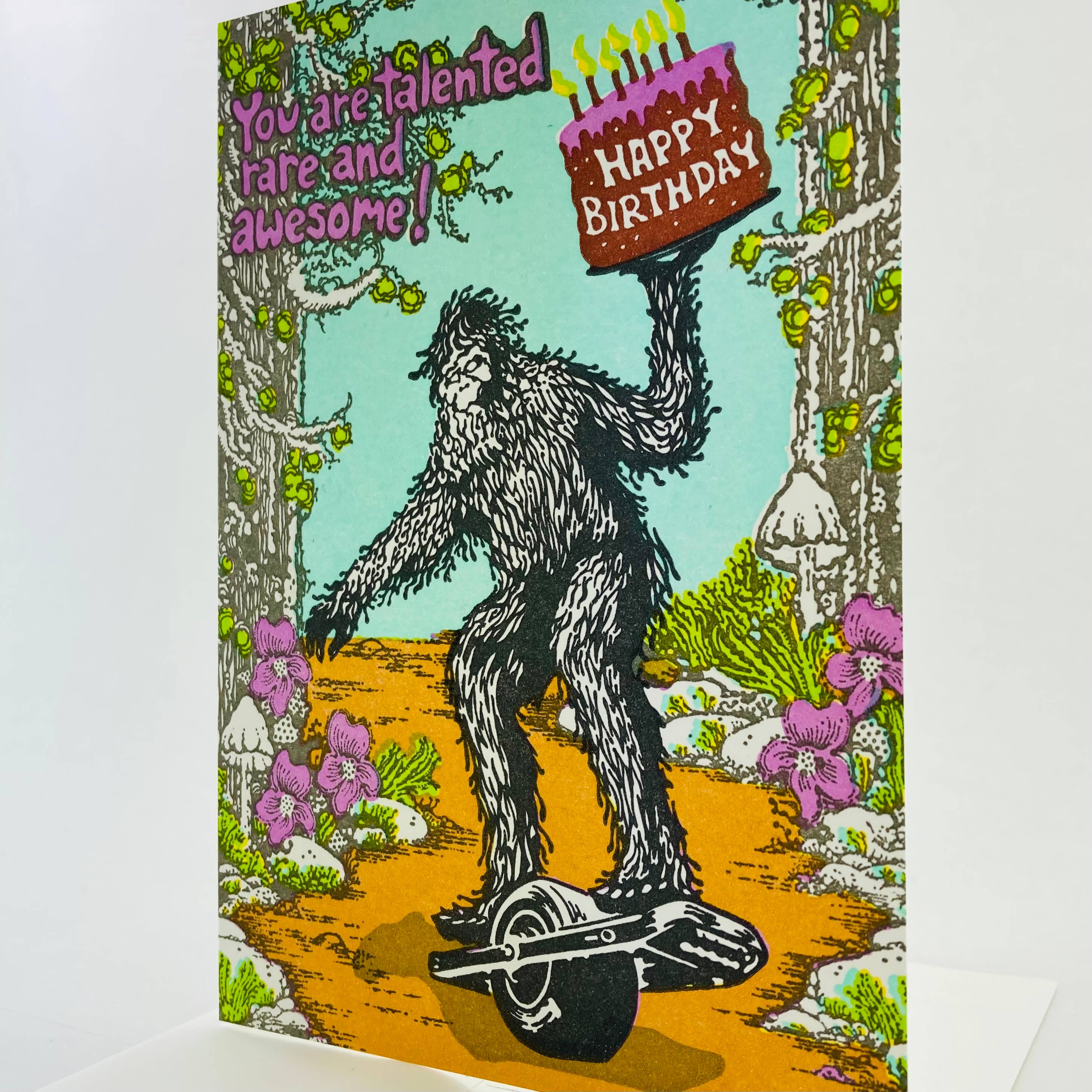 Old School Stationers - Wholesale Birthday Card - Happy Birthday Sasquatch riding a one wheel1