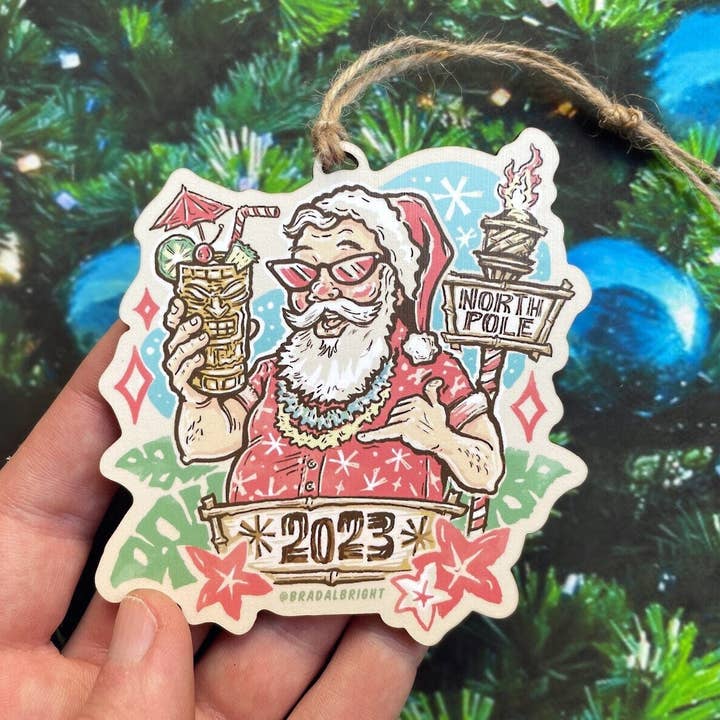 Tiki Santa 2023 Ornament - Mid Century Style Tropical Tiki Art - Wood and Twine Retro Santa Claus Christmas Tree Decor for wholesale by Albright Illustration & Design