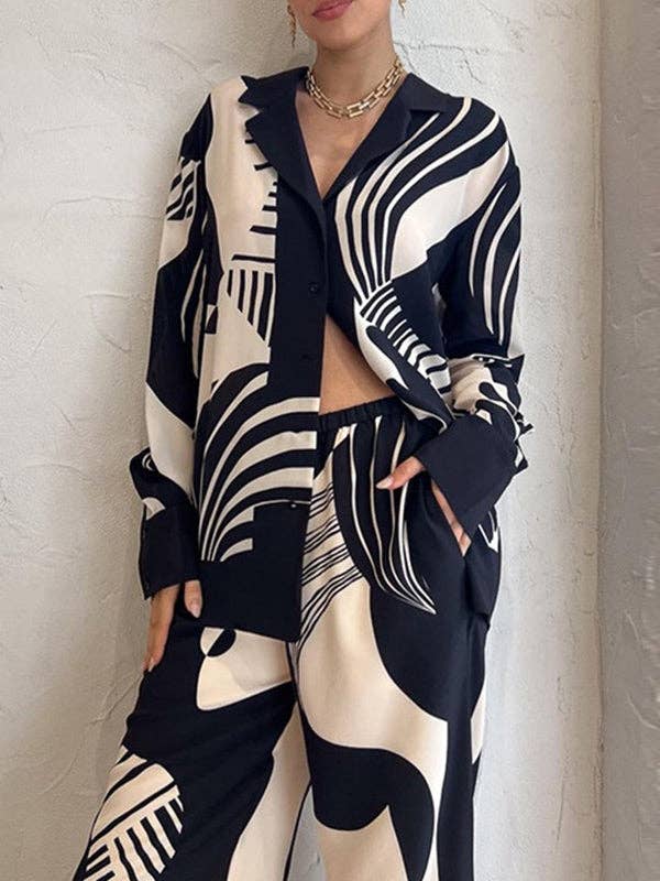 NERO Completo donna con blusa ampia a maniche lunghe e pantaloni con tasche e stampa in vendita all'ingrosso su Faire1