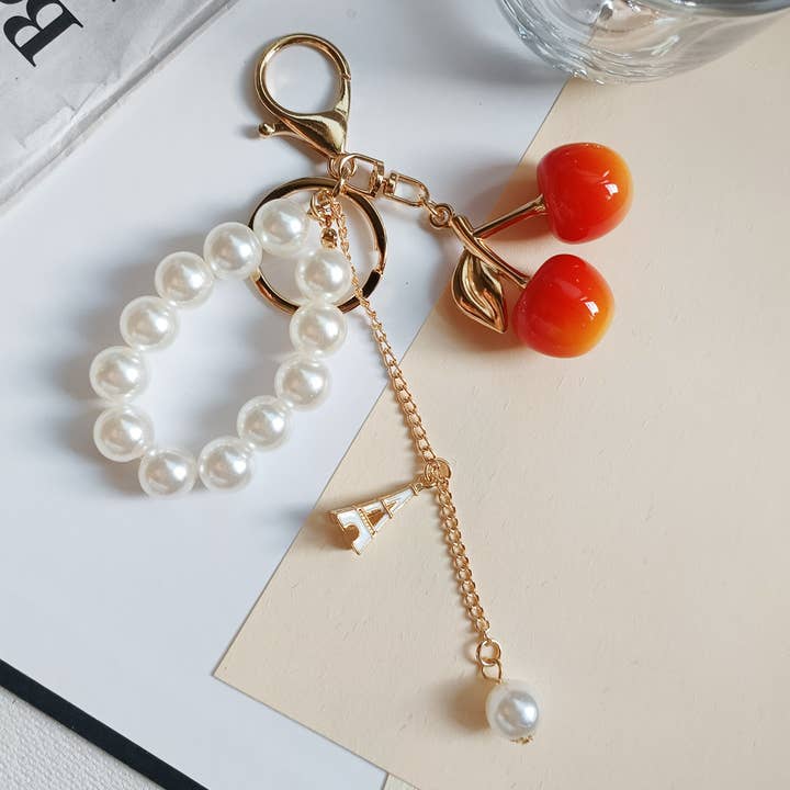 Ornaments-cherry pearl acrylic bag charm keychain for wholesale by Eagle Crest Industries Inc.