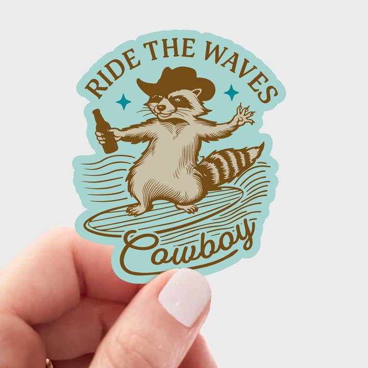 Ride the Waves Cowboy Sticker - raccoon, beer, aqua blue for wholesale by Yarnival