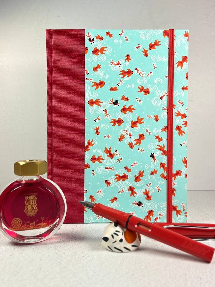 Carnet à couverture rigide A5 fini en tissu japonais rouge écarlate et motif de poissons Koi rouge/orange sur papier Chiyogami aqua. pour la vente par Graystorm Studio