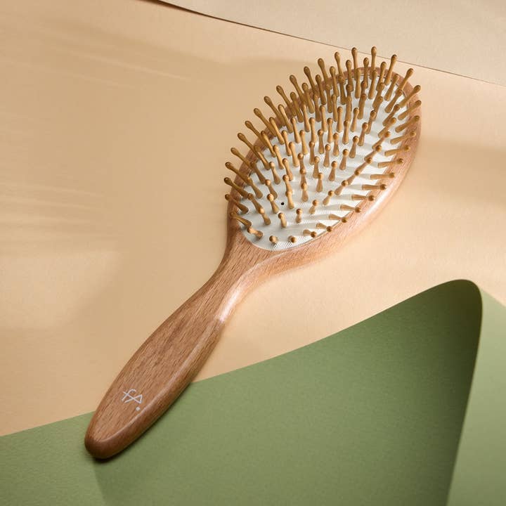 Oval massage hairbrush with wooden pins and knobs for wholesale by Fa brushes