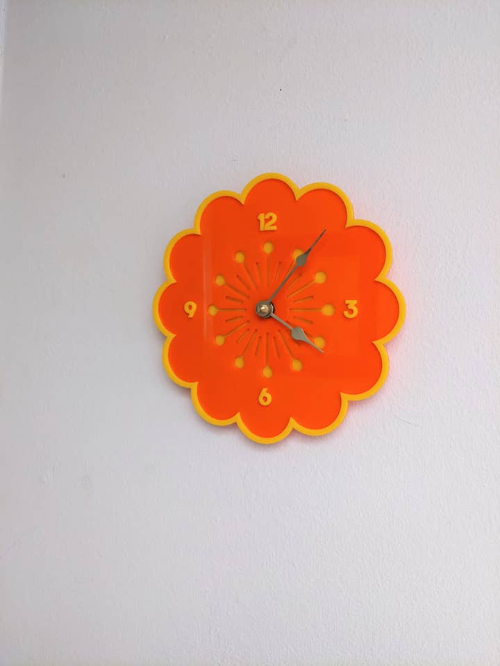 Retro Daisy Clock - Orange wit Yellow Trim for wholesale by Mostly Just Tired